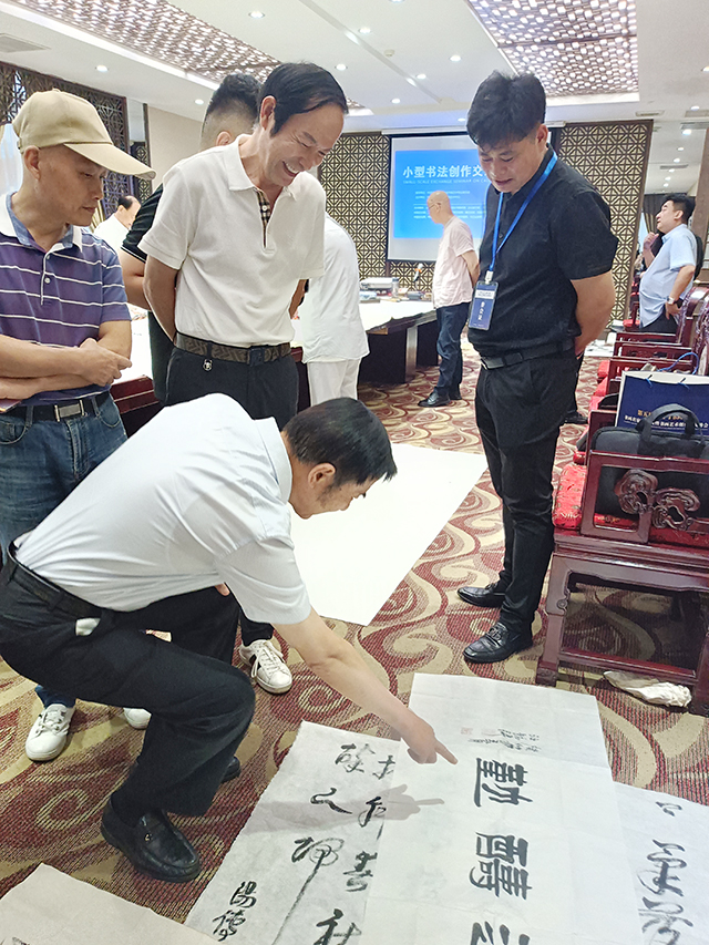 中国文联办公厅主任、中国民族建筑研究会书画艺术专业委员会主任罗杨给汪铭录秘书长现场作品点评.jpg
